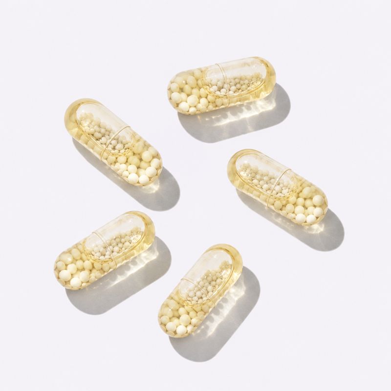 Capsules scattered on a white surface